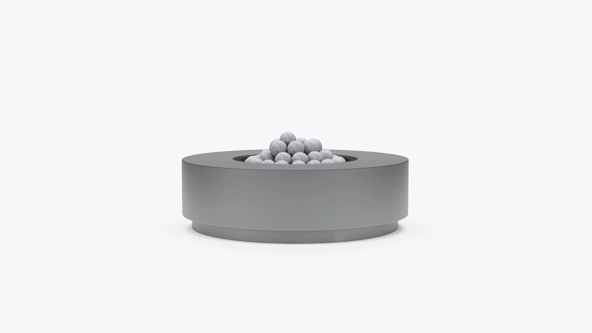 Round concrete outdoor fire pit table with recessed burner and fire stones